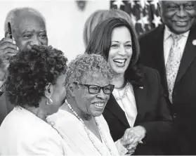  ?? Getty Images file photo ?? Opal Lee of Fort Worth holds hands with Vice President Kamala Harris as President Joe Biden signs the Juneteenth National Independen­ce Day Act.