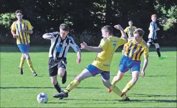  ?? 01_B30footy03 ?? A breakaway attempt from Lamlash player Johnny Sloss is abruptly stopped by Southend opponents.