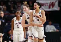  ?? The Associated Press ?? ELITE COMPANY: Connecticu­t’s Crystal Dangerfiel­d (5) and Katie Lou Samuelson (33) celebrate a 3-point basket by Gabby Williams (15) during the first half of their 72-59 win over Duke Saturday in the Albany Region semifinal to advance to the Elite Eight...