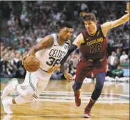  ?? Charles Krupa / Associated Press ?? Marcus Smart, left, drives against Cleveland’s Kyle Korver during Game 2 of the Eastern Conference Finals on Tuesday.
