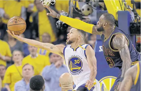  ?? AP ?? The Warriors’ Stephen Curry, left, shoots against the Cavaliers’ LeBron James in Game 1 of the 2017 NBA Finals.