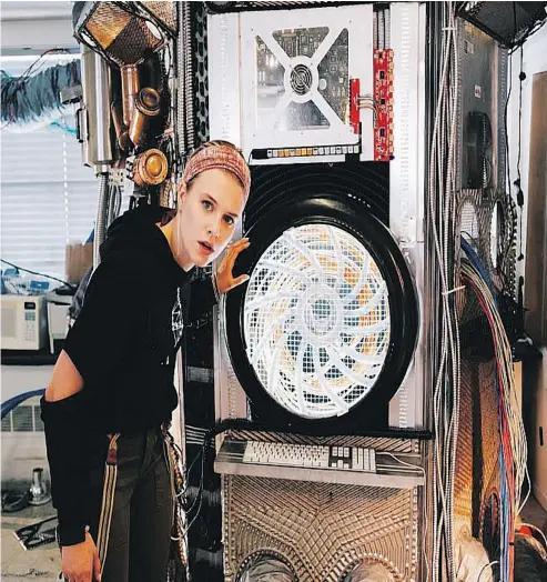  ??  ?? Tiera Skovbye poses in front of the Atomizer for the film Downloaded, an interactiv­e experience shot in Vancouver.