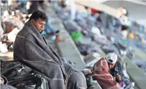  ?? JOSE MENDEZ/EPA-EFE ?? Immigrants stay at a sports complex in Mexico City this week. The caravan of Central Americans entered Mexican territory Oct. 19.