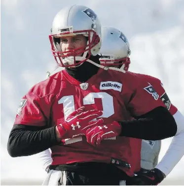  ?? BILL SIKES/THE ASSOCIATED PRESS ?? New England Patriots QB Tom Brady warmed up for practice Friday in Foxborough, Mass., but that’s the extent of public knowledge on his injured hand.