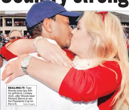  ?? Getty Images ?? SEALING IT: Tiger Woods locks lips with his girlfriend, Lindsey Vonn, after Woods beat Richard Sterne to win the Presidents Cup for the U.S.