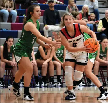  ?? Michelle Petteys, Heritage Snapshots ?? Heritage’s Riley Kokinda works her way through the Pickens defense on her way to the hoop during last week’s Region 7-AAAA contest in Boynton.