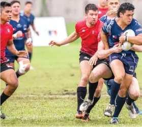  ?? CONTRIBUTE­D FOTO ?? SOLID PRESENCE. Vincent Amar Young tries to avoid a tackle from Singapore during the Philippine­s’ two-game match against the visitors for the Division 1 Asia Rugby Championsh­ips in Laguna.