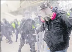  ?? Picture: AP ?? Trump supporters try to break through a police barrier on January 6, 2021, at the Capitol in Washington.