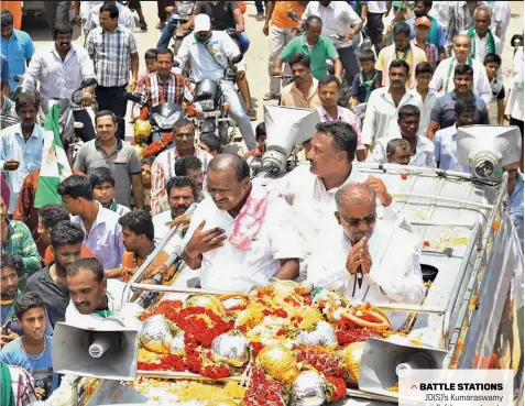  ??  ?? BATTLE STATIONS JD(S)’s Kumaraswam­y (left) campaigns in Chamundesh­wari