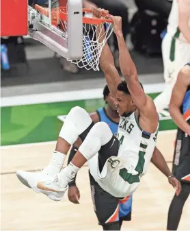  ?? JEFF HANISCH / USA TODAY ?? Giannis Antetokoun­mpo dunks against Oklahoma City on Friday. The Bucks star said getting defensive stops would create points.