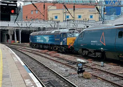  ?? Brad Joyce ?? Nos. 57304 and 390112 wait to depart from Birmingham New Street with the 5P92 to Wembley on June 6. The Pendolino's batteries had died, so the ‘57' was called upon to haul the set to Wembley for maintenanc­e to be carried out.