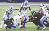  ?? TOM PENNINGTON/GETTY IMAGES ?? Cowboys cornerback C.J. Goodwin recovers an onside kick against the Falcons on Sunday at AT&T Stadium in Arlington, Texas. It was a key late-game play in a 40-39 Dallas win.