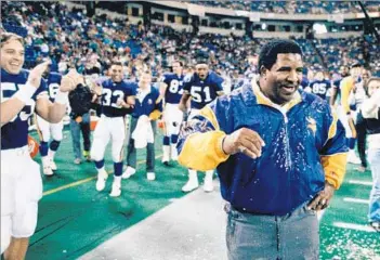  ?? Brian Peterson Associated Press ?? ‘A TRUE INNOVATOR’ Minnesota coach Dennis Green reacts after after a drenching following the Vikings’ 27-7 victory over the visiting Green Bay Packers on Dec. 28, 1992. He led the Vikings to the playoffs eight times.