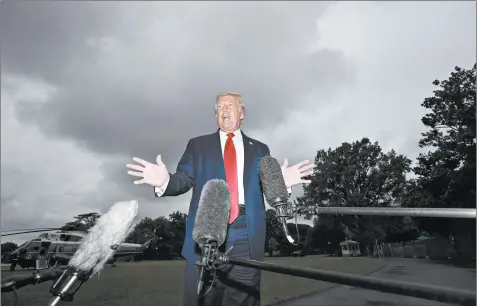  ?? ALEX BRANDON/AP ?? President Donald Trump speaks with reporters Friday before walking to a helicopter on the South Lawn of the White House in Washington, D.C..