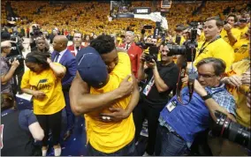  ?? RICK BOWMER - THE ASSOCIATED PRESS ?? FILE - In this April 27, 2018, file photo, Utah Jazz guard Donovan Mitchell, center, hugs his father as he walks off the court following Game 6of an NBA basketball first-round playoff series in Salt Lake City. Mitchell Sr., who works for the New York Mets, has tested negative for the coronaviru­s.