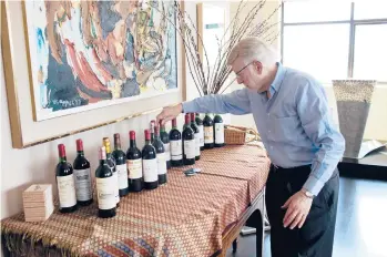  ?? RAYMOND MCCREA JONES/THE NEW YORK TIMES ?? Mark Taylor sets up bottles of 1982 Bordeaux for tasting in Atlanta in 2012. The 2005 Bordeaux vintage will require decades to evolve. Is that better than wines that are terrific sooner but not as majestic?.