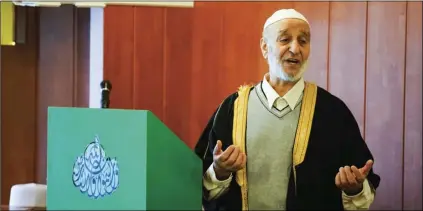  ??  ?? In this Feb. 23 photo, Imam Salmann Tamimi addresses the congregati­on at The Reykjavík Mosque during Friday midday prayers. He warned his multinatio­nal congregati­on about the proposed ban on circumcisi­on of boys for non-medical reasons and called it an...