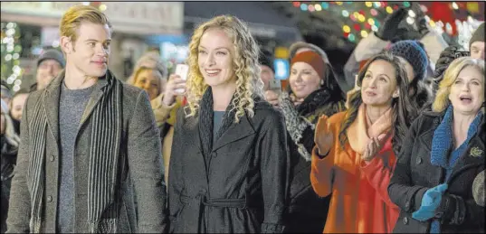  ?? Ricardo Hubbs Crown Media ?? Boutique owner Maddie Krug (Rachel Skarsten) meets her match in Johnny Blake (Trevor Donovan) in “Marry Me at Christmas.”