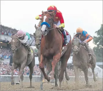  ?? ROB CARR — GETTY IMAGES ?? Justify, ridden by jockey Mike Smith, crosses the finish line first to win the 150th running of the Belmont Stakes.