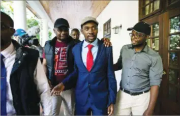  ??  ?? MDC-Alliance leader Mr Chamisa is led into a Harare hotel on August 3, to address a Press conference. — News wires