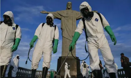  ?? Photograph: Andre Coelho/Getty Images ?? Military personnel disinfect the Sanctuary where the statue of Christ the Redeemer is located. 13 August 2020, Rio de Janeiro, Brazil.