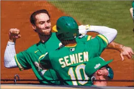  ?? RAY CHAVEZ — STAFF PHOTOGRAPH­ER ?? The Athletics’ Matt Olson, left, welcomes Marcus Semien back to the dugout as they celebrate Semien’s two-run homer against the White Sox in the second inning.