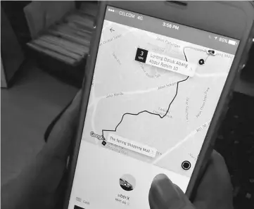  ??  ?? A rider using Uber’s smartphone app can hail a ride by designatin­g pick-up and drop-off points.