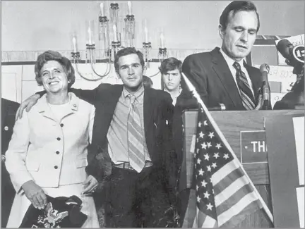  ?? Sam C. Pierson Jr. Houston Chronicle ?? POLITICAL FAMILY George W. Bush, center, his mother, Barbara, and his brother Jeb, background, watch as George H.W. Bush acknowledg­es his loss to Democrat Lloyd Bentsen Jr. in Texas’ 1970 U.S. Senate race. The younger Bush campaigned vigorously for his father.