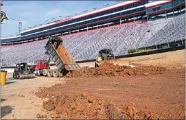  ?? DAVID CRIGGER / BRISTOL HERALD COURIER VIA AP FILE ?? Workers turn Bristol Motor Speedway into a dirt track, in Bristol, Tenn., in this Jan. 14 file photo. Bristol, once one of the toughest tickets in sports, trucked 23,000 cubic yards of dirt into its famed bullring to transform the facility and host NASCAR’s first Cup race on dirt in 50 years on Sunday.