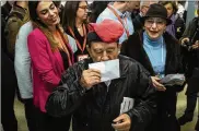  ?? DAVID RAMOS / GETTY IMAGES ?? A voter wearing a traditiona­l Catalan hat known as a barretina kisses his ballot before casting it Thursday in Barcelona, Spain, in an election of a new regional government.
