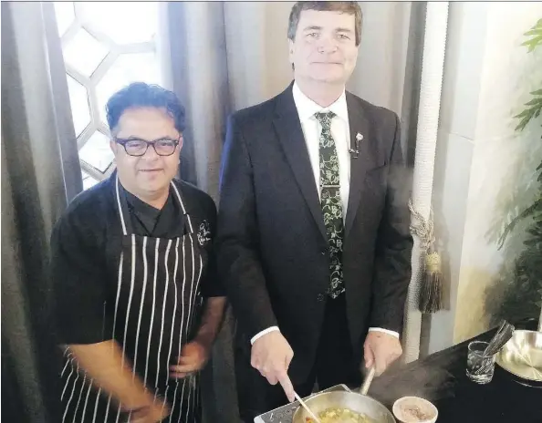  ??  ?? Alberta Agricultur­e Minister Oneil Carlier cooks with celebrity chef Vicky Ratnani during a recent trade mission to India.