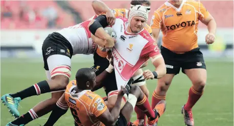  ??  ?? Len Massyn of the Lions is tackled during the recent Currie Cup rugby match against the Cheetahs at Ellis Park x Gavin Barker / BackpagePi­x