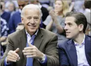  ?? NICK WASS, FILE - THE ASSOCIATED PRESS ?? In this 2010 file photo, Vice President Joe Biden, left, with his son Hunter, right, at the Duke-Georgetown NCAA college basketball game in Washington. Since the early days of the United States, leading politician­s have had to contend with awkward problems posed by their family members. Joe Biden is the latest prominent politician to navigate this tricky terrain.