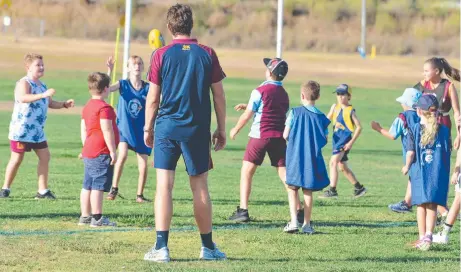  ?? Picture: Gerard Walsh ?? SIDELINED: Warwick Redbacks juniors were put through their paces during a Brisbane Lions clinic last year. Due to a drop in player numbers the club will not field teams in the AFLDD junior competitio­n this season.
