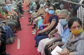  ?? Associated Press ?? People wait to receive a COVID vaccine in Mumbai, India, on April 29.