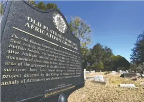  ?? AP PHOTOS/JULIE BENNETT ?? Old Plateau Cemetery, the final resting place for many who spent their lives in Africatown, stands in need of upkeep near Mobile, Ala., Jan. 29. Many of the survivors of the Clotilda’s voyage are buried here amongst the trees.