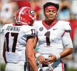  ?? CURTIS COMPTON / CCOMPTON@AJC.COM ?? Georgia coaches are looking for opportunit­ies to get freshman quarterbac­k Justin Fields (right) more playing time.