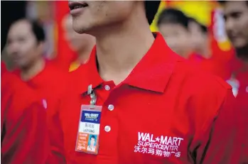  ?? ADAM DEAN/BLOOMBERG NEWS ?? In 2006, Walmart, which owns 411 stores in China, became the first foreign company to accept unionizati­on of its workers. But activists say the official union has largely stood on the sidelines.