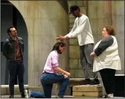  ?? Courtesy Photo ?? Chandler Reid Evans, John Lackey, kneeling, described as “a wonderful young bass-baritone,” Jordan Brown and Jennifer Nesbitt rehearse for “Man of La Mancha,” a collaborat­ion between the University of Arkansas theater and music department­s.