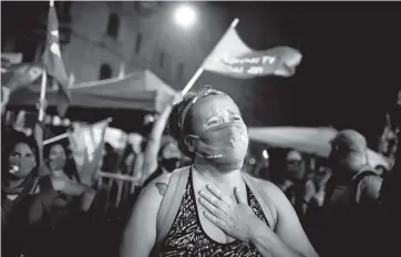  ?? NATACHA PISARENKO AP ?? An abortion-rights activist reacts outside Congress in Buenos Aires on Wednesday after lawmakers legalized abortion.