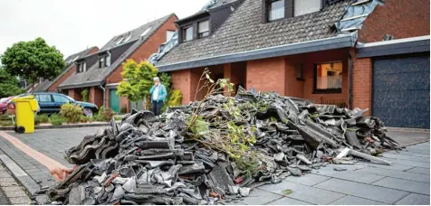  ?? Foto: Marius Becker, dpa ?? Szenen der Zerstörung im nordrhein westfälisc­hen Viersen: Bei einem Wirbelstur­m abgedeckte Dachziegel liegen zusammenge­räumt an einer Straße. Ein Tornado hatte im Raum Viersen gewütet und mindestens zwei Menschen verletzt.