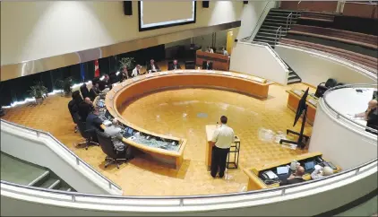  ?? NEWS PHOTO COLLIN GALLANT ?? Dr. Lucas Gursky, a medical officer of health with Alberta Health Services, speaks at Monday’s public hearing on retail cannabis store regulation­s at Medicine Hat city council's meeting. AHS’s position is to take a cautious approach to zoning the...