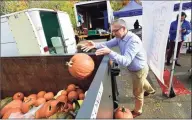  ?? Erik Trautmann / Hearst Connecticu­t Media file photo ?? Local residents including Horst Gallo, of Westport, bring their pumpkins to Action Waste Solution’s Great Pumpkin Toss, a free community composting event, at the Westport Farmers Market on Nov. 11.