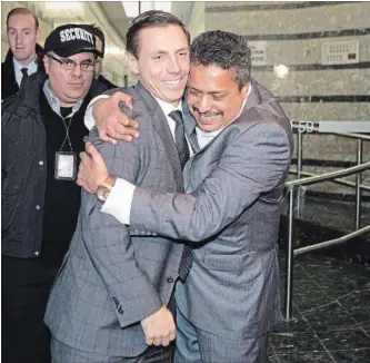  ?? CHRIS YOUNG THE CANADIAN PRESS ?? PC leadership candidate Patrick Brown is hugged by Prakash Venkataram­an as they leave the Ontario PC Party head office in Toronto Tuesday, after Brown was vetted by party officials and allowed to run for his old job.