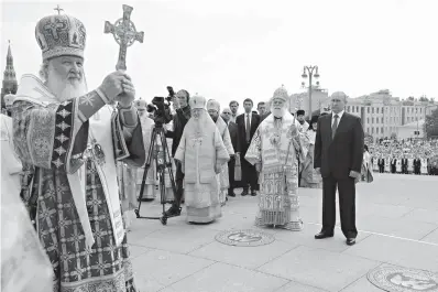  ?? Mikhail Klimentyev, Sputnik, Kremlin Pool Photo via AP ?? ■ Russian Orthodox Church Patriarch Kirill, left, leads a religious service July 28 as Russian President Vladimir Putin, right, and Eastern Orthodox Patriarch of Alexandria and all Africa Theodoros II, second right, attend a ceremony marking the 1,030th anniversar­y of the adoption of Christiani­ty by Prince Vladimir, the leader of Kievan Rus.