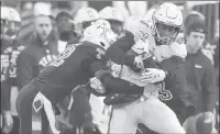  ??  ?? UConn wide receiver Heron Maurisseau tries to break free from Temple safety Benny Walls on Saturday in Philadelph­ia.