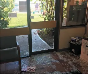  ?? HANDOUT PHOTO BY JARROD BELL ?? Broken glass covers the floor of a foyer at the Peace River North School District office in Fort St. John, after a young moose smashed its way inside on Wednesday.