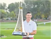  ?? AFP ?? Rory McIlroy holds the Race to Dubai trophy after the DP World Tour Championsh­ip.