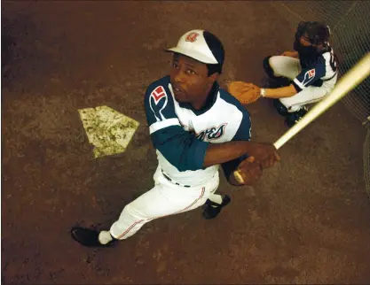  ?? THE ASSOCIATED PRESS FILE PHOTO ?? Hank Aaron, who endured racist threats with dignity during his pursuit of Babe Ruth and broke the career home run record in 1974, died Friday.