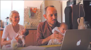  ?? Photo: Reuters ?? Coming home… Namibian citizen Phillip Lühl holds one of his twin daughters as his mother Frauke Lühl looks on while he speaks to his Mexican husband Guillermo Delgado via Zoom.